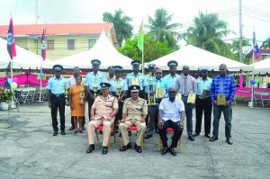 Police Commissioner Seelall Persaud and Assistant Commissioners David Ramnarine and Brian Joseph, along with some of the top performing ranks who were awarded, including Best Cop Prem Narine (blue shirt) and Runner-up Best Cop Herbert Henry (grey shirt) 