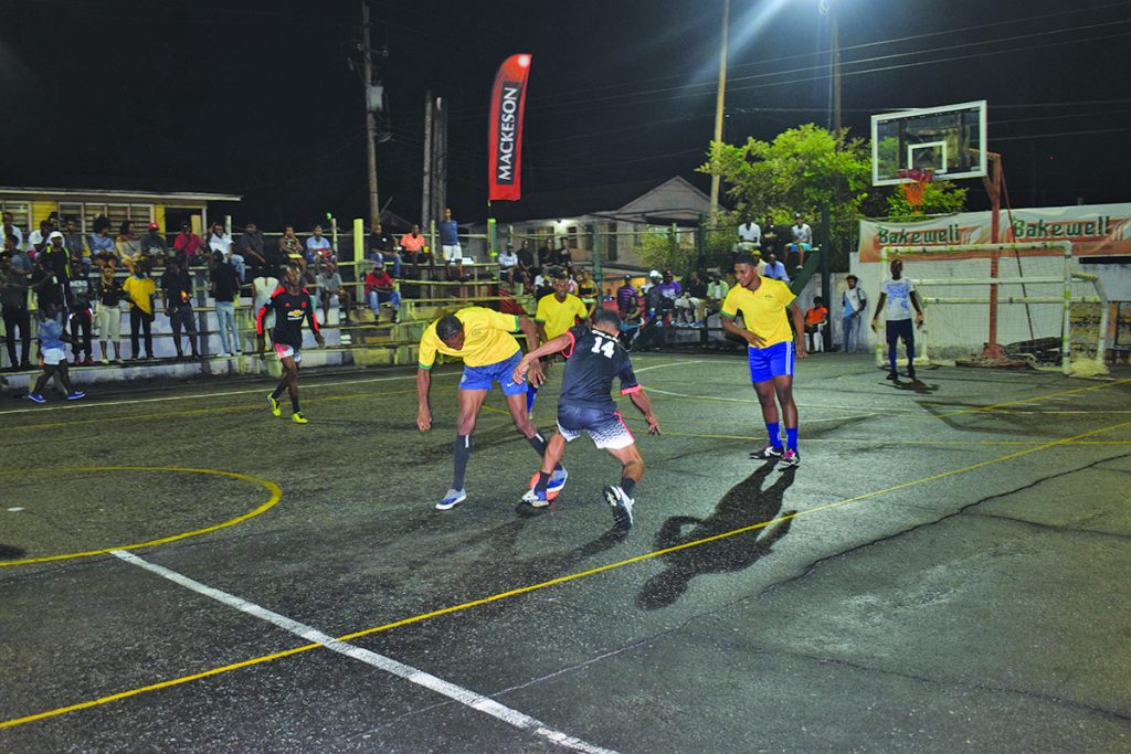 Hustler’s Deon “Crab” Charter works his way through the defence of West Side Ballers 