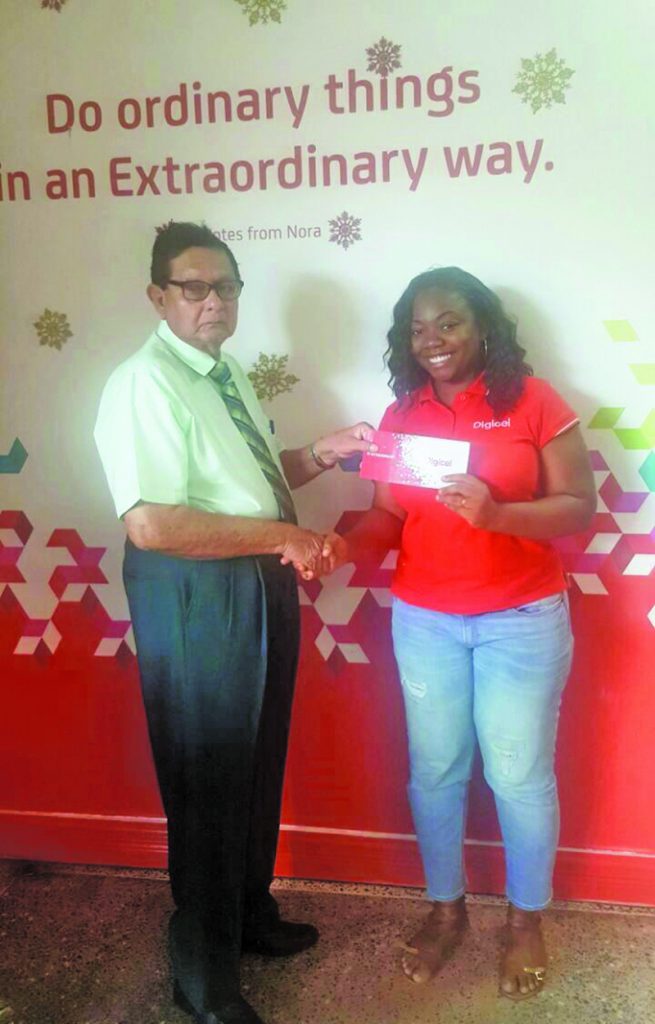 Louanna Abrams handing over sponsorship cheque to Justice Kennard, organizer of 2016 edition of Annual Kennard’s Turf Club Memorial Boxing Day horse race meet 