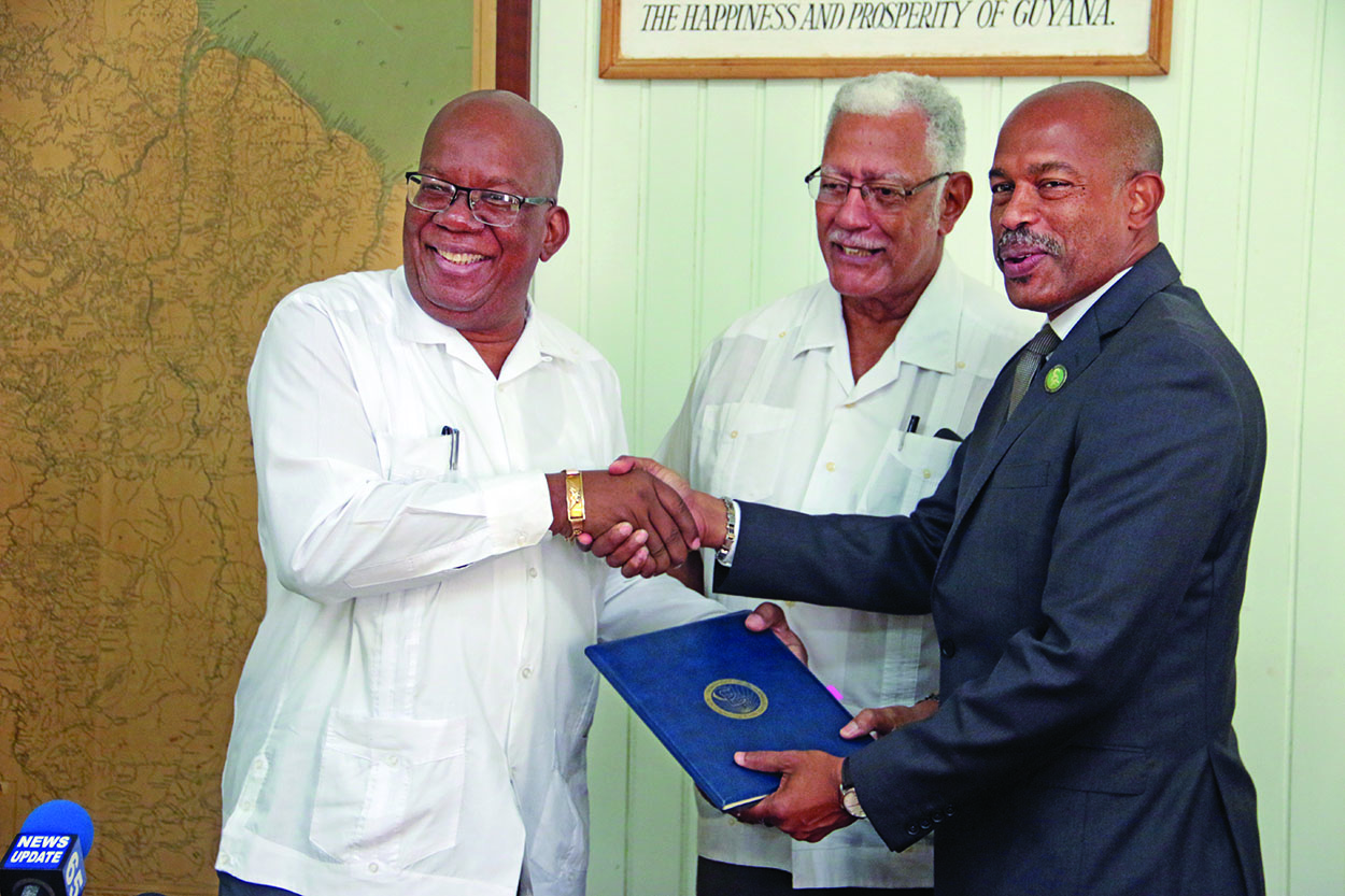 Finance Minister Winston Jordan and CDF’s CEO Rodinald Soomer after signing the loan and grant agreements as Agriculture Minister Noel Holder looks on 