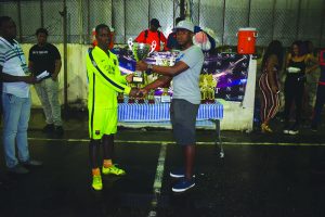 Magic Stars’ Captain Jermaine Grandison (green shirt) receives his second place prize