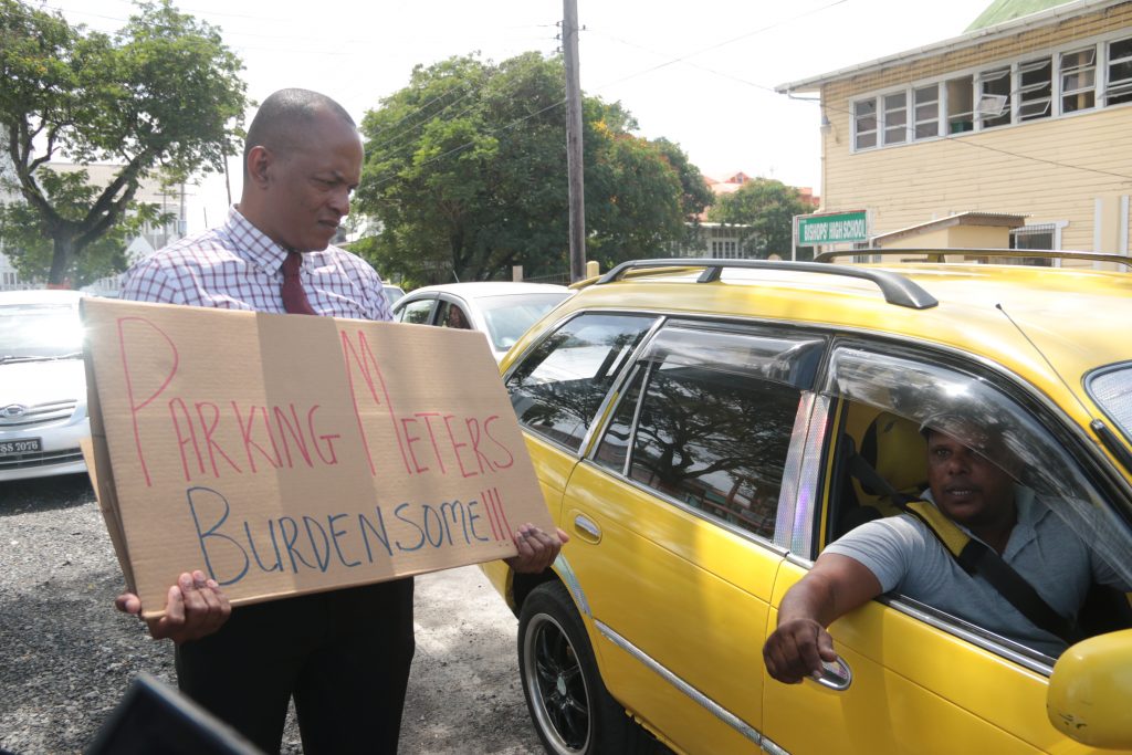 Deputy Mayor Sherod Duncan receives encouragement from a passing motorist, during his protest on Carmichael Street 