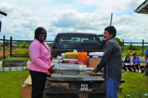 Minister within the Public Health Ministry, Dr Karen Cummings hands over a fogging machine to Shea Toshao John Agustus 