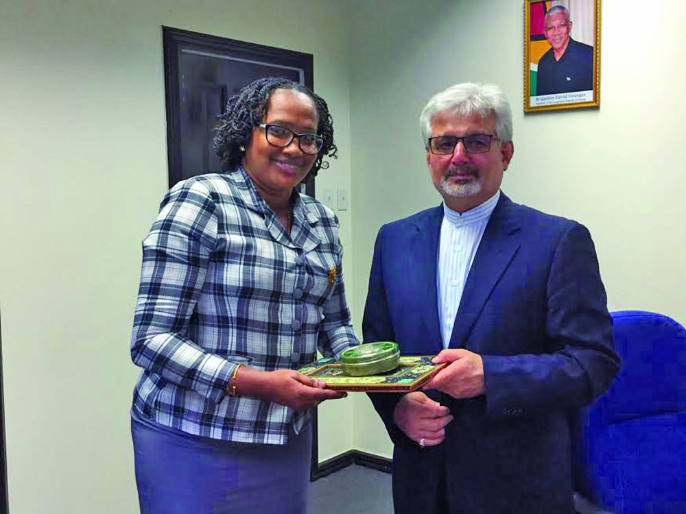 Minister within the Public Infrastructure Ministry, Annette Ferguson, receives a token from Iranian Ambassador, Mostafa Alaei