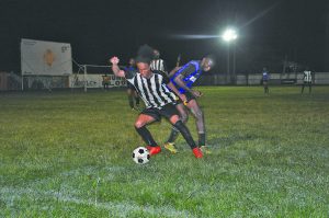 Santos’ Job Caesar who netted a double beats Uitvlugt’s defender at the Tucville Ground