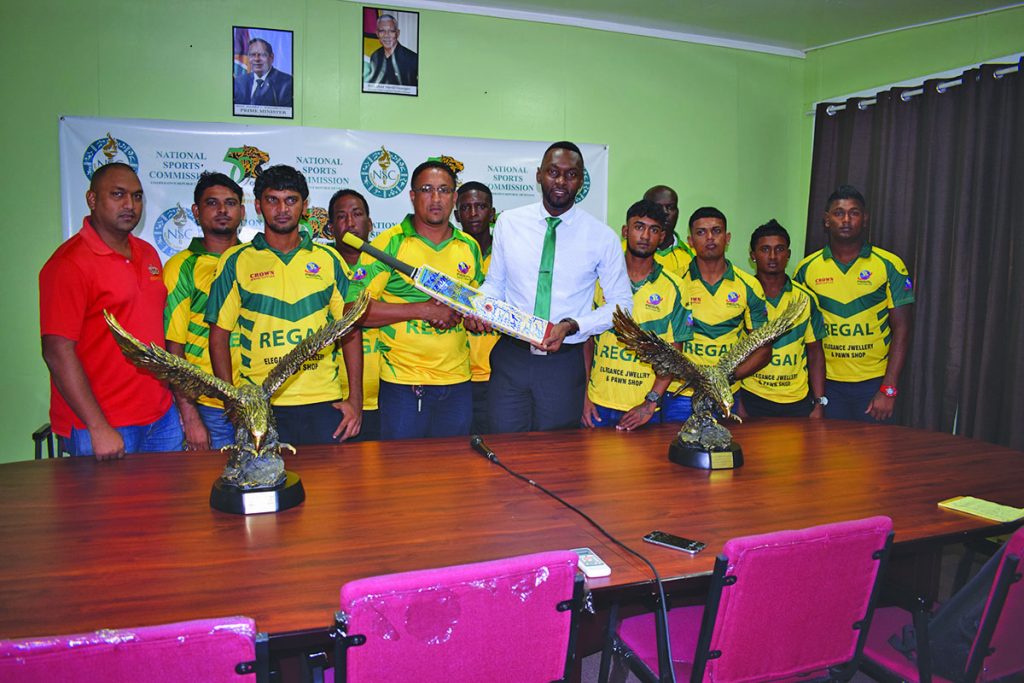 Regal All-Stars Captain, Richard Latif presents an autograph bat to Director of Sport, Christopher Jones on behalf of the Regal Teams. All-Star Manager, Parmanand Persaud is at extreme left 