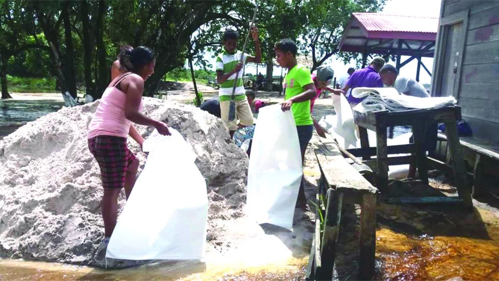 Sands bags being filled to alleviate flood waters from the lake