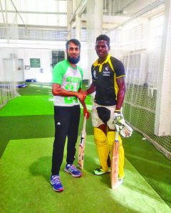 Shaquille Williams (right) with South African spinner Imran Tahir 