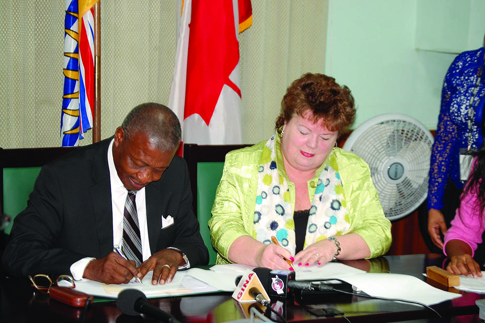 Speaker of Guyana’s National Assembly, Dr Barton Scotland and Speaker of the Legislative Assembly in British Columbia, Linda Reid, signing the agreement  