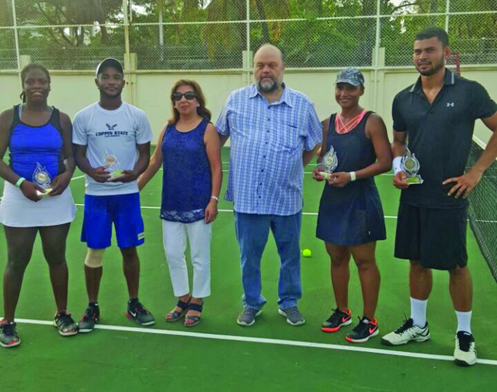 US Ambassador Perry Holloway and his wife Rosaura Holloway (centre) pose with Afruica Gentle and Gavin Lewis (left) and Rebecca Mitchell and Anthony Downes (right) after the match 
