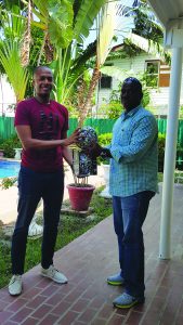  The composite photo shows Clinton Urling handing over Futsal balls to Franklin Wilson (left) and to President of the Coaches Association, Wayne Dover and Vice-President Sampson Gilbert