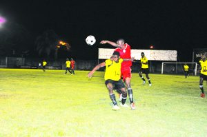 Randolph Wagner (#14) tussles with Guyana Police Force FC’s Kevon Mc Pherson for possession