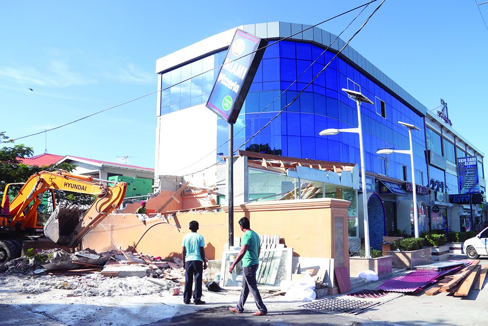 M&CC workers tore down the “illegal” extension on this Sheriff Street business on Thursday