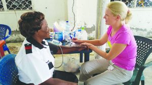 A volunteer facilitating blood pressure testing