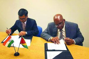 Finance Minister, Winston Jordan, and Indian Exim Bank Representative, Sailesh Prasad, signing the agreement on Wednesday  
