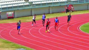 Arinze Chance (red top) running out of lane lowered his personal best in the 300M dash to 33.79s