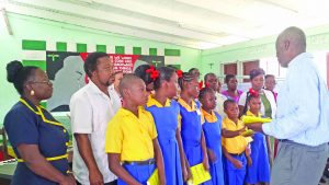 Children of Watooka being distributed to students and teachers on Monday in  Linden by a representative of author Steve Connolly