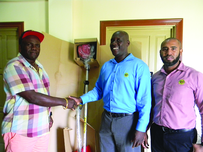 President of Bayroc Club Lancelot Easton (left) shakes hand with Guyana Cricket Board (GCB) Territorial Development Officer (TDO) Colin Stuart. GCB staff Anthony D’Anrade looks on  