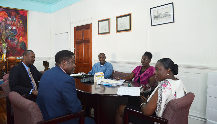 FIFA Director, Mosengo-Omba in discussion with Minister Henry in the presence of GFF and Ministry Officials 