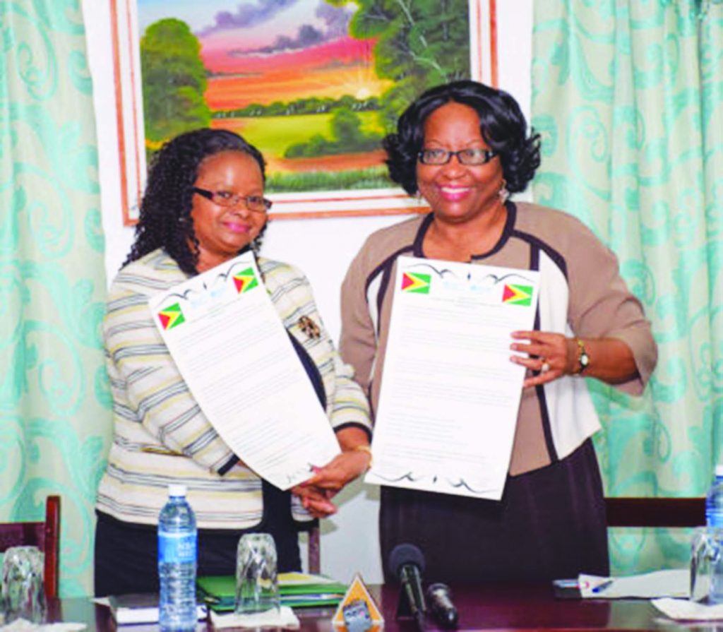 Public Health Minister Volda Lawrence and Pan American Health Organisation/World Health Organisation (PAHO/WHO) Director, Dr Carissa Etienne exchange the signed Country Cooperation Strategy (CCS) 2016-2020 