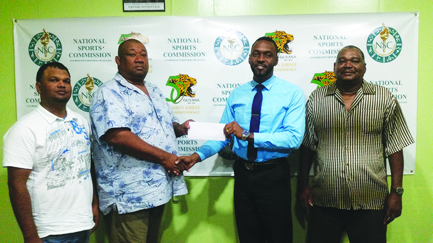 Director of Sports Christopher Jones hands over sponsorship to RHTY&SC’s Hilbert Foster in presence of Sohan Harry (extreme right) and Mark Papannah