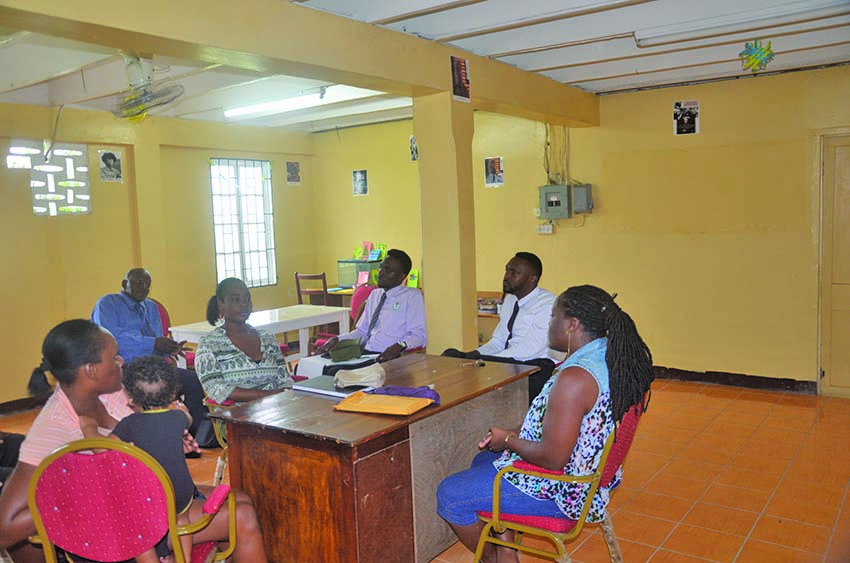 Director of Sport Christopher Jones (right), along with Deputy Director of Sport Brian Smith, engaged in discussion with community members on Wednesday