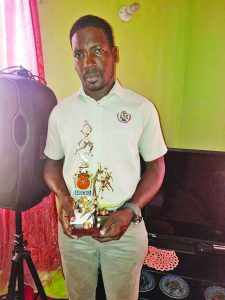 LABA President Lawrence Simon posing with one of the trophies for the tournament 