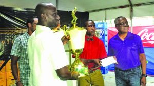 A representative of Silver Shattas receiving trophy during the awards ceremony