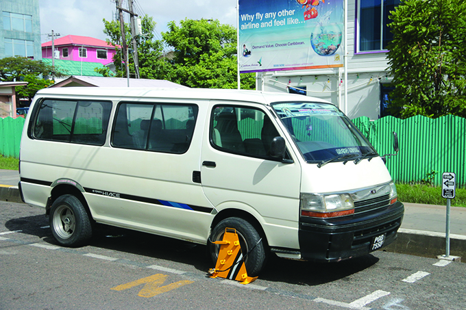 A minibus with a clap from SCS for a parking violation