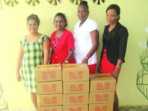 Teachers of the four schools pose with some of the educational materials 