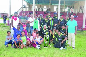 Oudit Prasad (standing at right) shares the moment with the new champions, Sans Souci Jaguars in the presence of WCC Secretary Nazeer Mohamed (standing second from left)