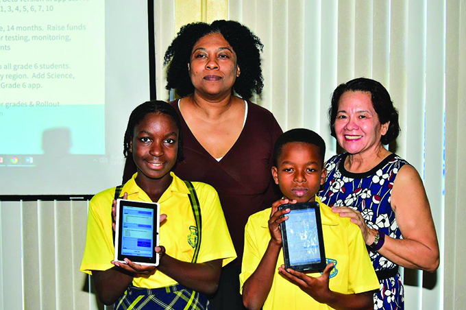 First Lady Sandra Granger poses with Karen Abrams and two Grade Six students who attended the launch 