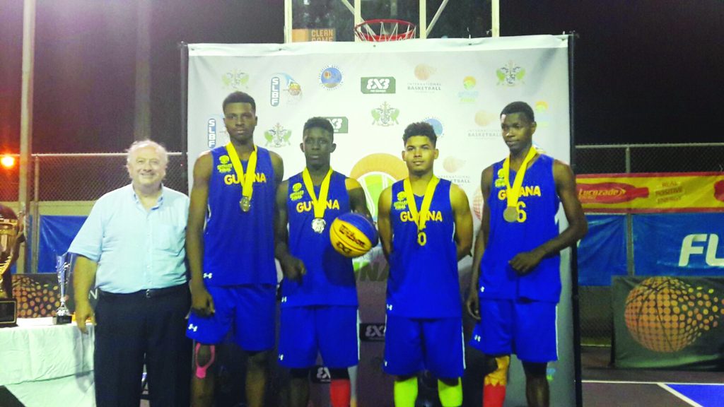 The Guyanese contingent with their silver medals along with FIBA President Horacio Muratore 