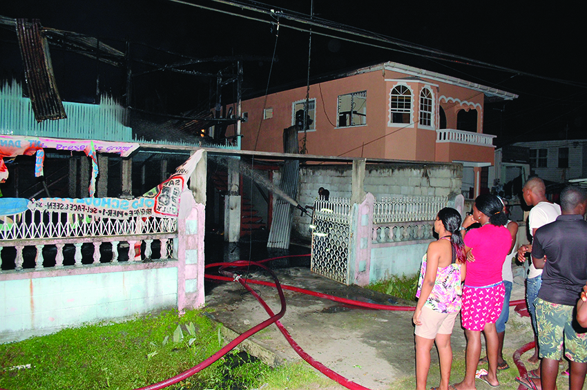 Persons gathered at the scene of the fire