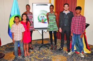 Twin sisters Jadyn and Daniel George along with Phillip DeNobrega and other swimmers unveiling the meet’s logo  