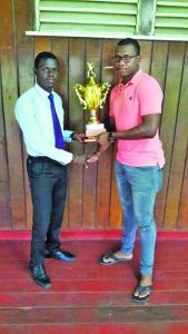 Christopher Barnwell (left) hands over the winning trophy to Dexter George