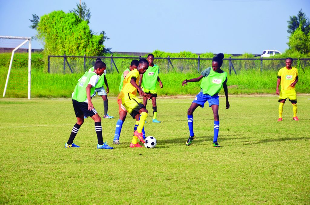 Kelsey Benjamin (with ball) was torn in the defence of North Ruimveldt with   his canny dribbling skills on Saturday at the Ministry of Education Ground 