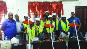 Public Infrastructure Minister David Patterson, Regional Chairman Renis Morian, Member of Parliament Audwin Rutherford and members of the Region 10 CORE group and other officials pose alongside some of the donated gear 