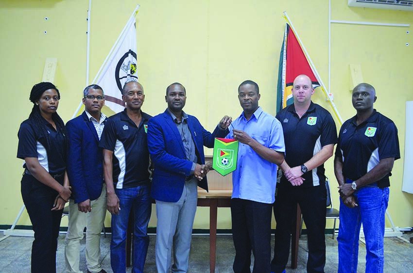 Mayor of Linden, Carywn Holland (third from right) and GFF President, Wayne Forde confirm the deal in the presence of other members of the football body 