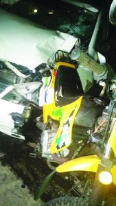 The mangled motor car and the motorcycle following the accident