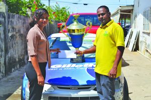 Procter and Gamble coordinator Diana Alley making the Donation to drag racer Anand Ramchand