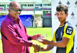 Tagenarine Chanderpaul accepts a commemorative plaque on behalf of his father Shivnarine Chanderpaul from Governor General of St Kitts and Nevis, Sir SW Tapley Seaton 