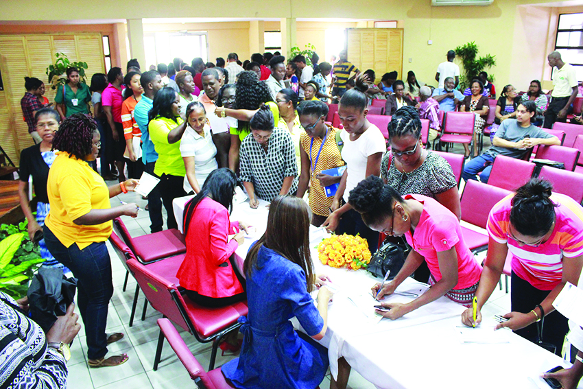 Students of the University of Guyana signing up for their Giftland Mall’s VIP Card 