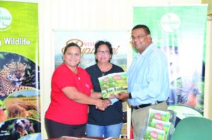 The Visit Rupununi team and Director of the Guyana Tourism Authority (GTA) Indranauth Haralsingh display the Rupununi folders 
