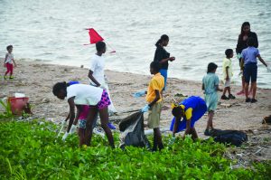 Hard at work! National swimmers among other junior swimmers engaged in the clean-up exercise at the Kingston Seawall