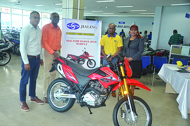 Representatives from the GFF and Jialing strike a pose with the 250cc bike that a lucky fan will collect at the end of the competition  