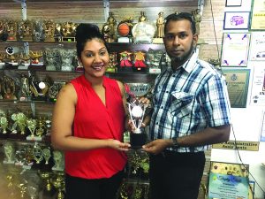 GCF’s Irshad Mohamed receives one of the trophies from Emma Sunich Hussain (daughter of Ramesh Sunich)