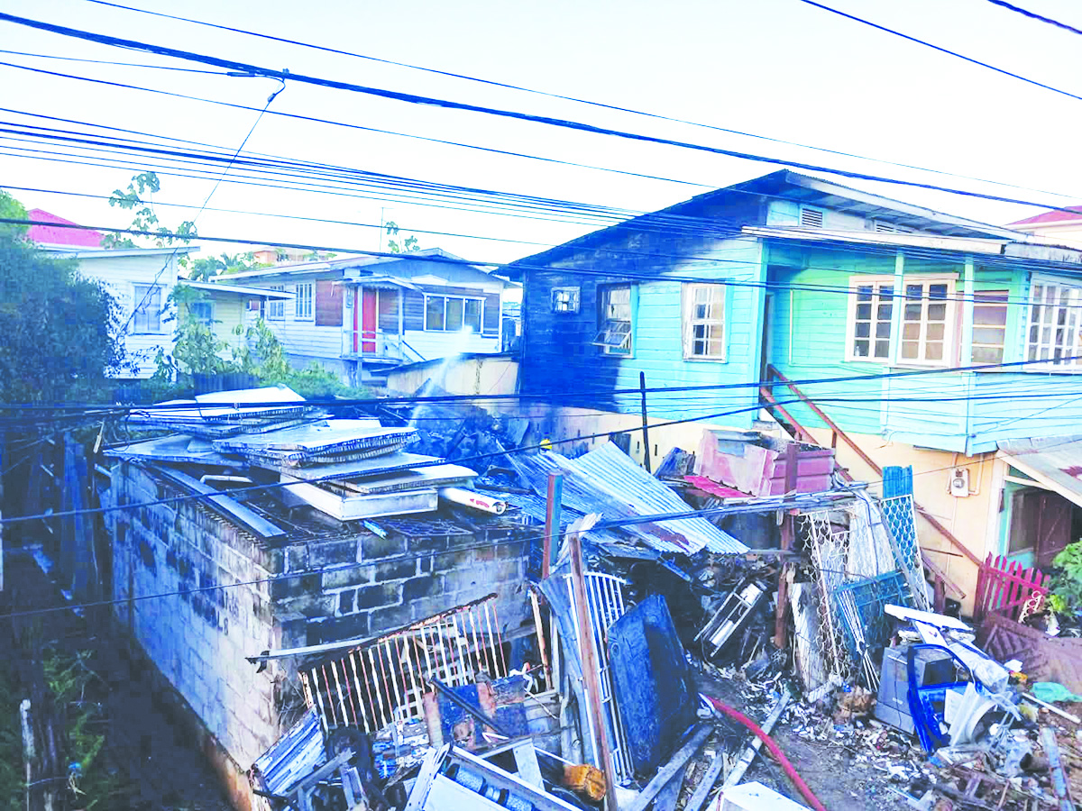 Rubbish fire spreads to house